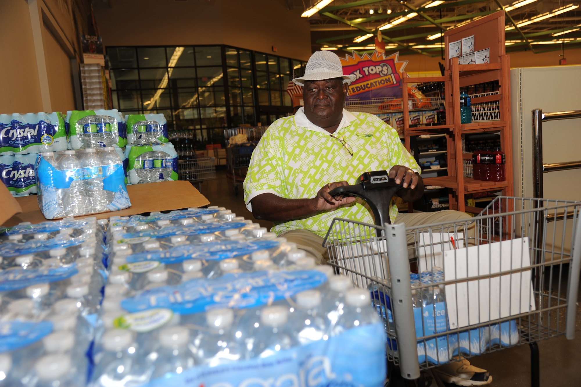 A.J. Breland, Army retired of Brooklyn, Miss., loads his grocery cart with cases of water and other hurricane supplies into her trunk Aug. 27, 2012, at Keesler Air Force Base, Miss.  Keesler personnel are taking preventative measures to prepare and protect themselves and Keesler's assets as the base commander has declared HURCON 3, meaning destructive winds of 58 MPH or greater are expected as Isaac approaches. (U.S. Air Force photo by Kemberly Groue)