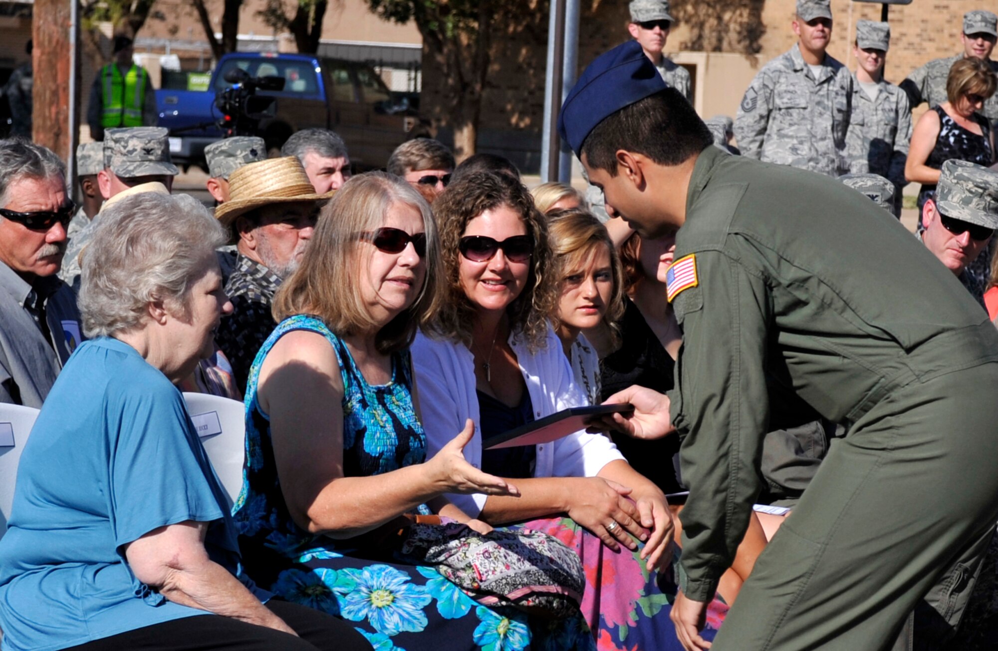 Members of the Ricci family receive a gift from base leadership while attending the street renaming ceremony for Airman 1st Class Richard Albright at Cannon Air Force Base, N.M., Aug. 27, 2012. Albright was killed in action while serving in the Korean War and in order to honor his sacrifice Cannon leadership renamed Trident Ave. to Albright Ave. (U.S. Air Force photo/Airman1st Class Ericka Engblom)