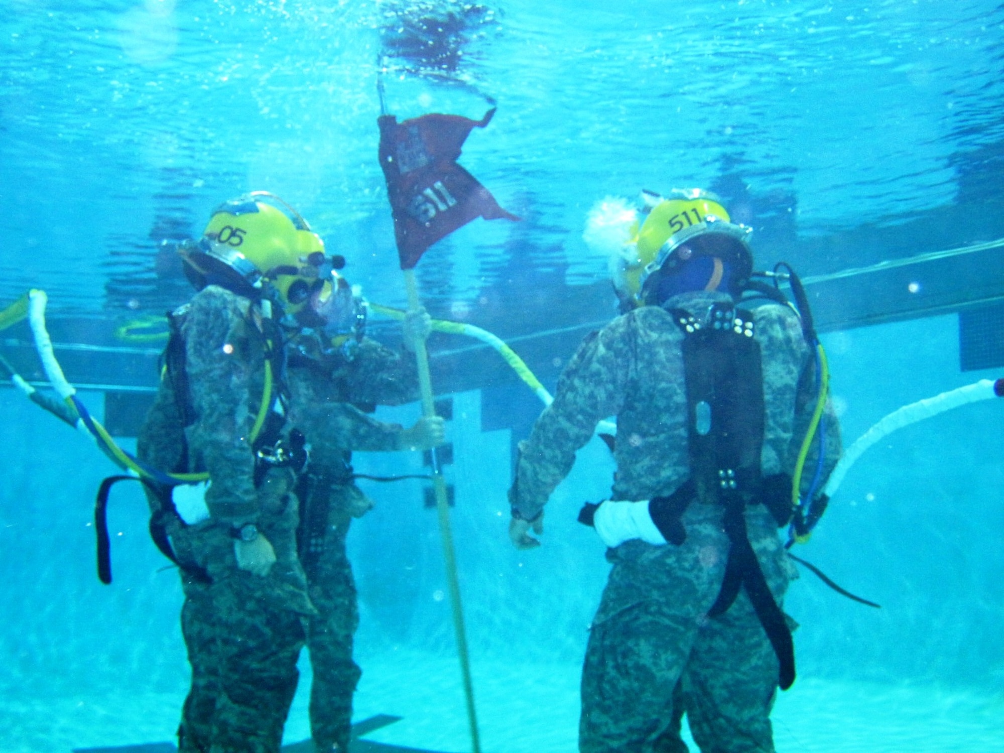 The 511th Dive Detachment, supported by the Special Troops Battalion, 7th Sustainment Brigade, hosted an underwater change of command ceremony at the Aquatic Center on Fort Eustis, Aug. 24. The traditional passing of the detachment colors was performed completely underwater. (Photo by Sgt. Sky Schofield, 511th Dive Detachment)