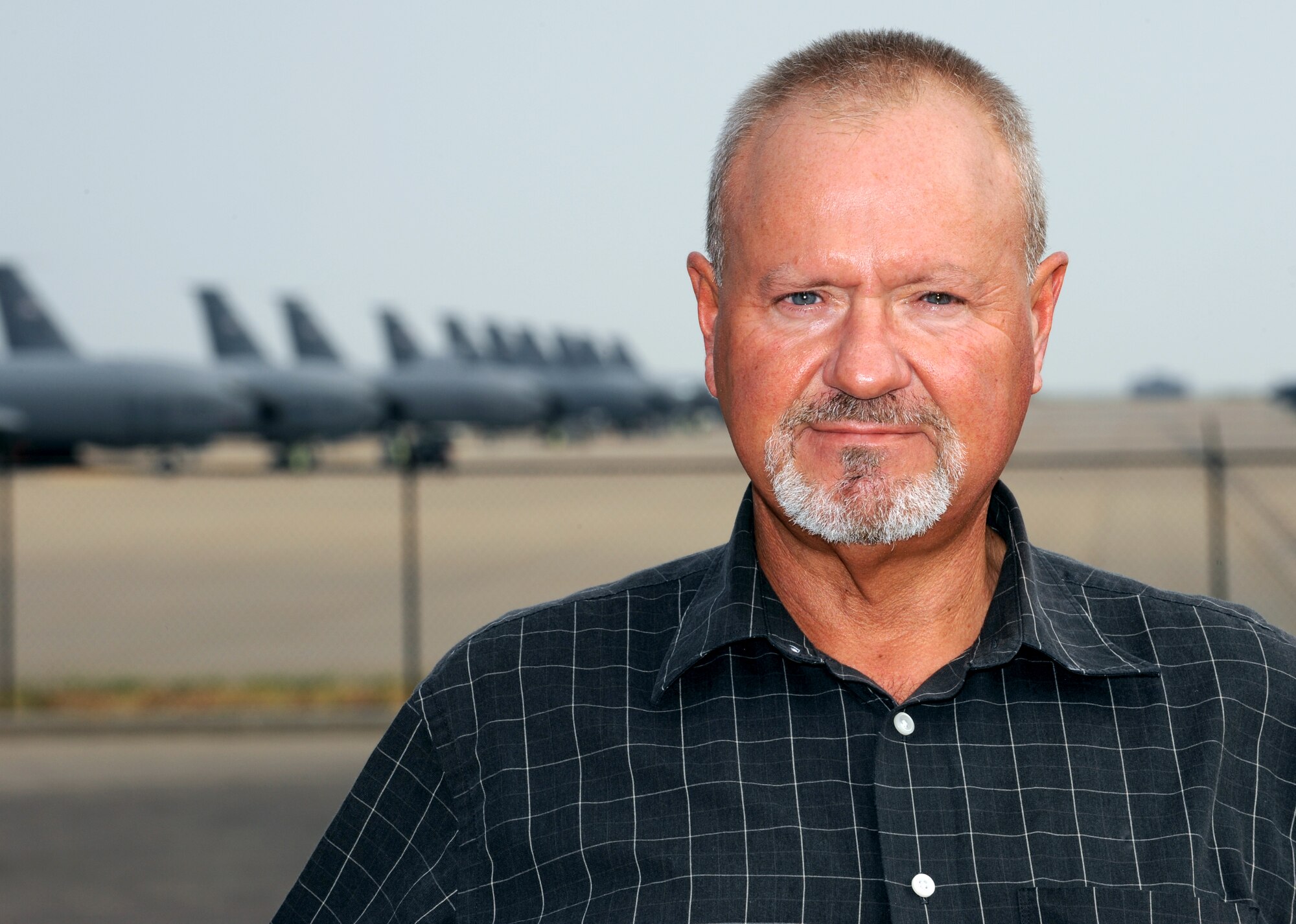Jim Shores, 22nd Operations Support Squadron short range scheduling chief, poses for a portrait outside of the flightline, Aug. 23, 2012, McConnell Air Force Base, Kan. Shores was awarded $10,000 as part of the Innovative Development through Employee Awareness program for saving Air Mobility Command approximately $472 thousand a year in fuel waste. (U.S. Air Force photo/Airman 1st Class Jose L. Leon)