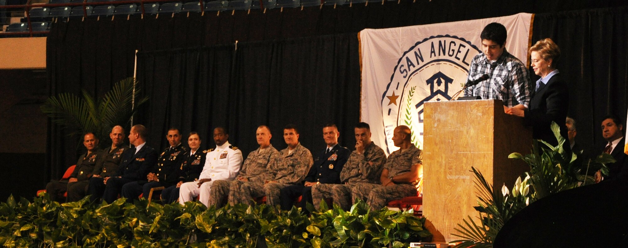 Leaders from Team Goodfellow represent the base community at the San Angelo Independent School District "Back-to-School" convocation while Dr. Carol Ann Bonds, San Angelo school district Superintendant, and Nic Dehoyos, Lake View High School graduate, welcome everyone to the event at the Foster Communications Coliseum Aug.23. Bonds wanted to emphasize that the care for the children of military families' from Goodfellow was very important to SAISD. (Air Force Photo/ Airman 1st Class Erica Flores)