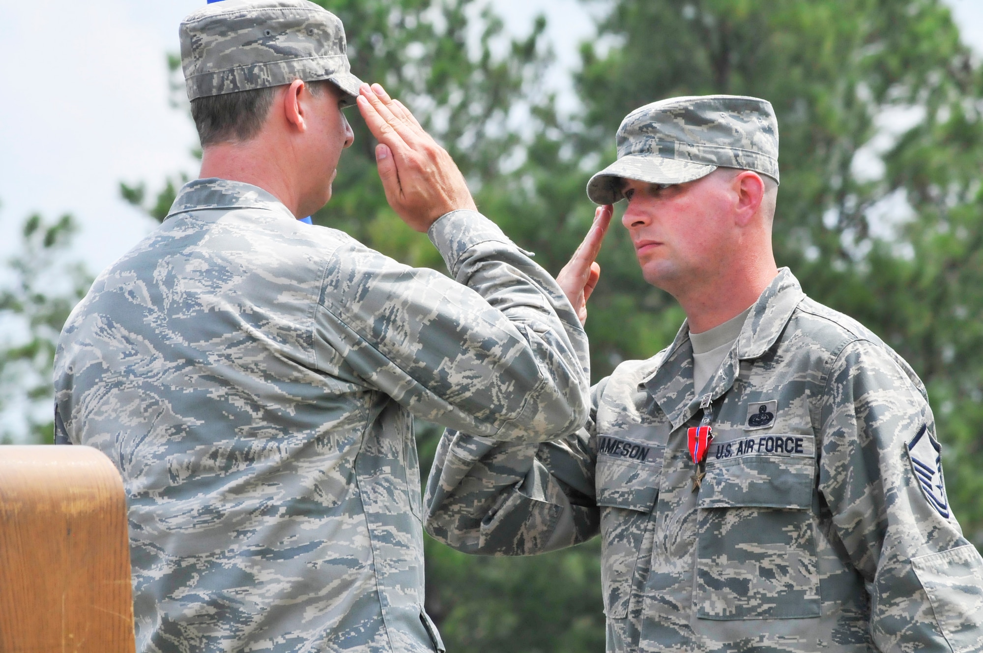 Col. Joseph H. Scherrer, 689th Combat Communications Wing commander presents the Bronze Star Medal with Valor on Master Sgt.Gene B. Jameson, III, in a ceremony August 23. Sgt. Jameson received the medal for heroism while deployed to Bagram Airfield, Afghanistan. (U. S. Air Force photo/Sue Sapp)