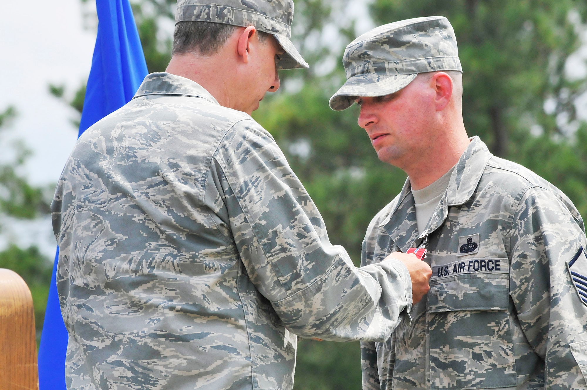 Col. Joseph H. Scherrer, 689th Combat Communications Wing commander pins the Bronze Star Medal with Valor on Master Sgt.Gene B. Jameson, III, in a ceremony August 23. Sgt. Jameson received the medal for heroism while deployed to Bagram Airfield, Afghanistan. (U. S. Air Force photo/Sue Sapp)