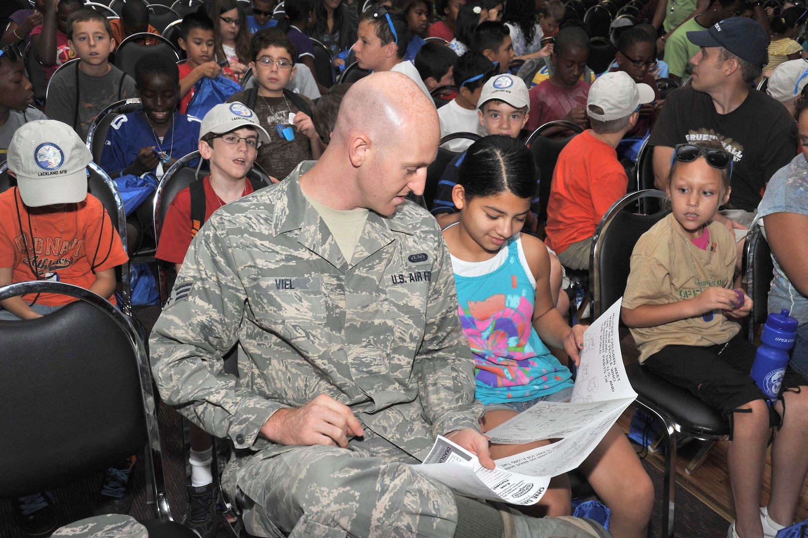 Mya Collins, 11, and her legal guardian, Senior Airman H. Brooks Viel III, a military training instructor with the 322nd Training Squadron, read their “deployment orders” prior to deploying to Camp Justice Aug. 10. Operation Junior Expeditionary Team, commonly called Operation JET, is a one-day mock deployment event, which gives military children insight to what their parents experience during actual deployments.
active-duty Airmen in different fields to gain an understanding of career responsibilities and knowledge of daily Air Force operations, and to interact with enlisted members. (U.S. Air Force photo/Alan Boedeker)