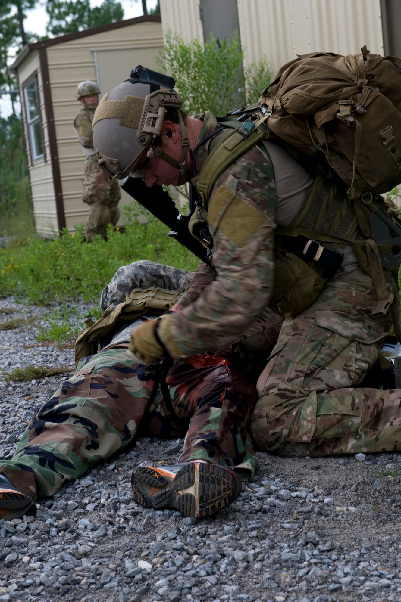 A U.S. Air Force pararescueman applies a tourniquet to a simulated improvised explosive device victim during a training exercise on Eglin Range, Fla., Aug. 21, 2012. The scenario played out included a simulated I.E.D. explosion in a building, as part of an upgrade training requirement for Air Force pararescuemen.(U.S. Air Force Photo/ Staff Sgt. John Bainter)