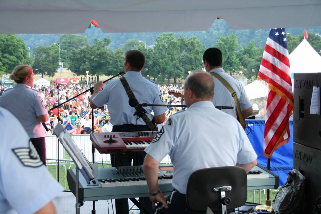 Members of the rock band High Altitude, a component of the 553rd ANG Band of the Mid-Atlantic, entertain a crowd at the Three Rivers Regatta in Pittsburgh, Pennsylvania on the 4th of July.  The Unit made several concert stops in the Pittsburgh area over their Summer AT Concert Series. (U.S. Air Force Photo by Master Sergeant Kevin Martin)