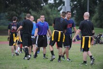 U.S. Air Force Airmen from the 4th Logistics Readiness Squadron and 916th Air Refueling Wing shake hands after a flag football game on Seymour Johnson Air Force Base, N.C., Aug. 21, 2012. The defending base champions, 4th LRS, won the game 26-0. (U.S. Air Force photo/Airman 1st Class Aubrey Robinson/Released)