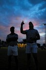 A referee performs a coin toss prior to a flag football game on Seymour Johnson Air Force Base, N.C., Aug. 21, 2012. The coin flip at the beginning of each game determines which team will receive the ball first. (U.S. Air Force photo/Airman 1st Class Aubrey Robinson/Released)