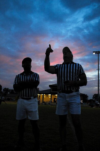 A referee performs a coin toss prior to a flag football game on Seymour Johnson Air Force Base, N.C., Aug. 21, 2012. The coin flip at the beginning of each game determines which team will receive the ball first. (U.S. Air Force photo/Airman 1st Class Aubrey Robinson/Released)