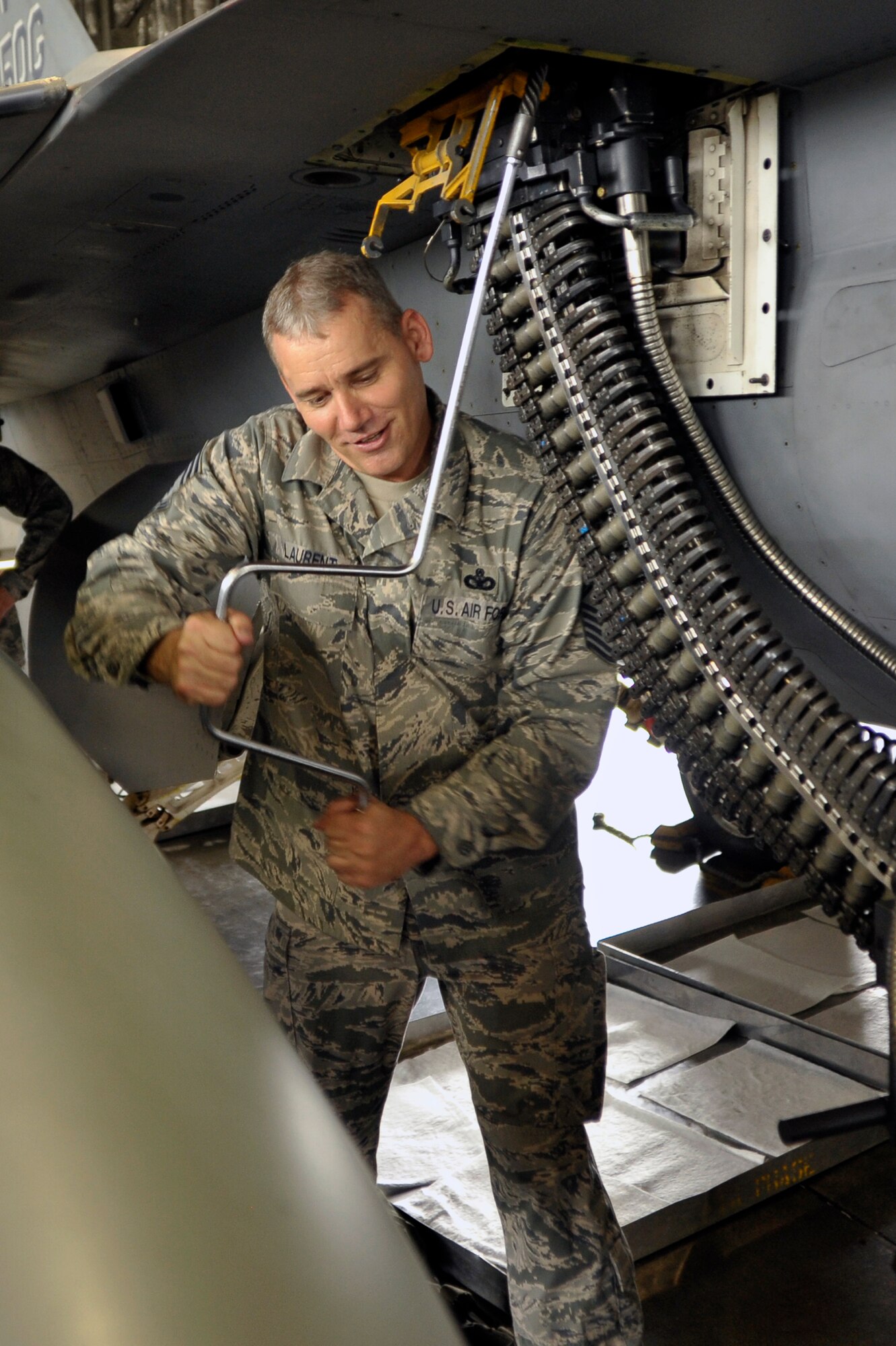 U.S. Air Force Chief Master Sgt. James Laurent, 35th Fighter Wing command chief, runs rounds through the M61A1 "Vulcan" 20mm Rotary Cannon on a F-16 Fighting Falcon at Misawa Air Base, Japan, Aug. 24, 2012. The Vulcan fires roughly 6,000 rounds per minute and has a high muzzle velocity of 1,036 meters per second. (U.S. Air Force photo by Staff Sgt. Nathan Lipscomb/Released)