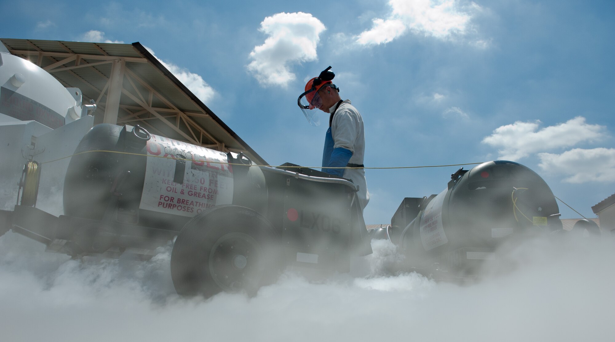 YOKOTA AIR BASE, Japan -- Staff Sgt. Samuel Aldrich, 374th Logistics Readiness Squadron Cryogenics supervisor, oversees liquid oxygen transferring to a 50-pound cart at Yokota Air Base, Japan, on Aug. 24, 2012. Oxygen freezes at -368.77 degrees Fahrenheit and causes large amounts of vapor and condensation when in contact with ambient air temperatures. (U.S. Air Force photo by Airman 1st Class John D. Partlow)