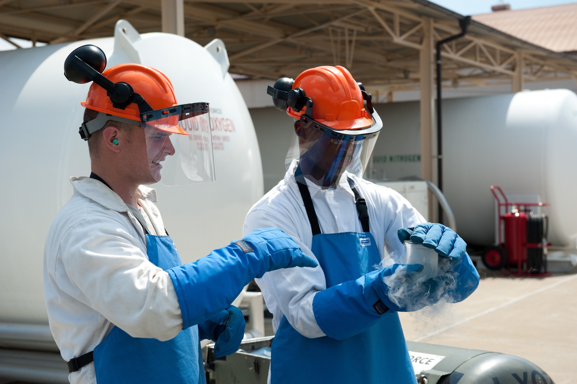 YOKOTA AIR BASE, Japan -- Staff Sgt. Samuel Aldrich, left, 374th Logistics Readiness Squadron cryogenics supervisor, and Airman 1st Class Tevin Smith, 374 LRS fuels distribution apprentice, seal a liquid oxygen sample at Yokota Air Base, Japan, on Aug. 24, 2012. The cryogenics lab personnel takes samples of their LOX and tests them to ensure they are at least 99.5 percent pure oxygen. (U.S. Air Force photo by Airman 1st Class John D. Partlow)