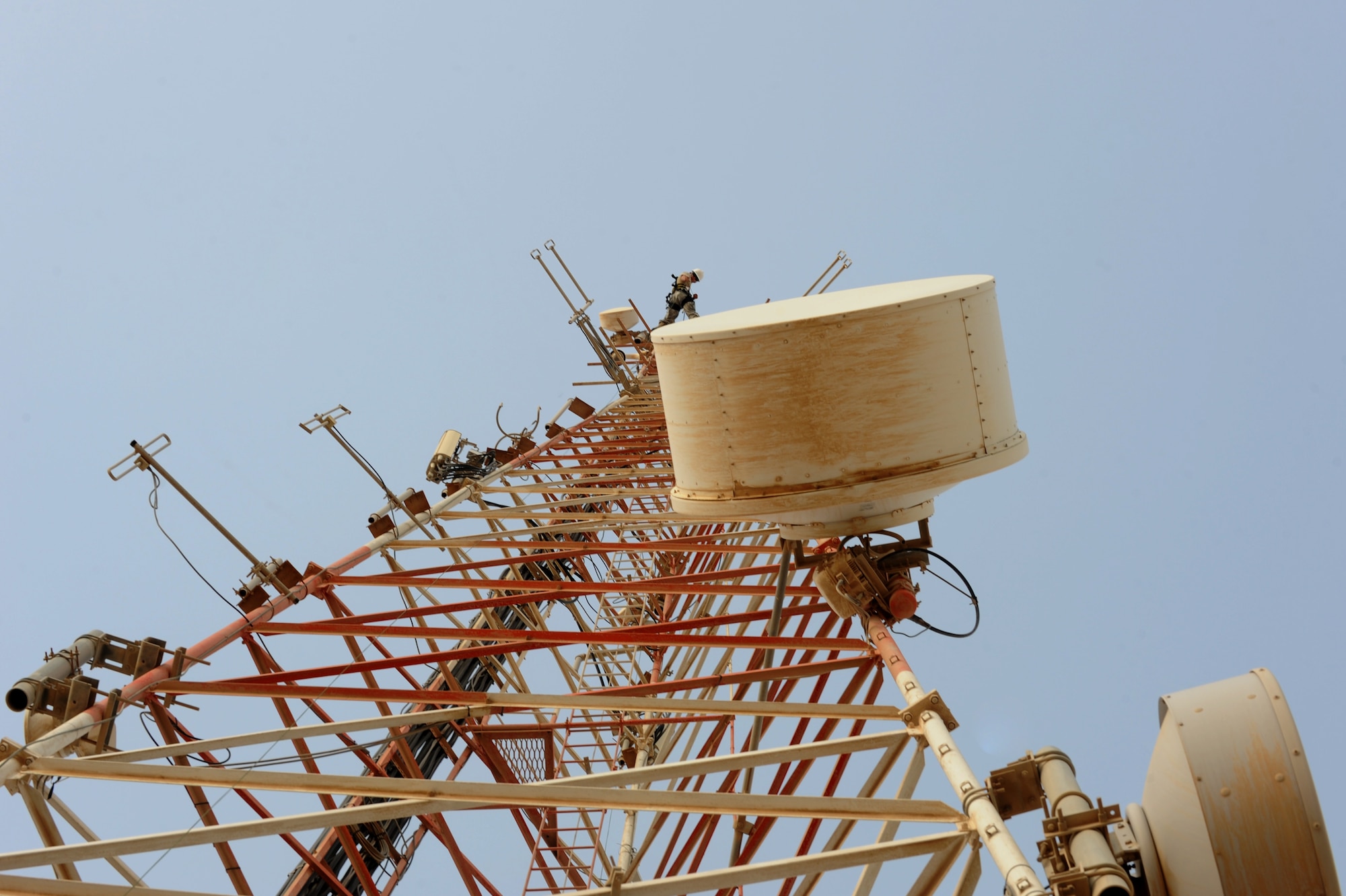U.S. Air Force Senior Airman Cyrus Torres lowers a rope prior to moving two high frequency ground-to-air antennas in Southwest Asia, August 7, 2012. The move is in preparation for the construction material holding yard for the Technical Control Facility and Network Control Center expansion. Torres is assigned tot he 379th Expeditionary Communication Squadron and is deployed from Aviano Air Base, Italy. (U.S. Air Force photo/Staff Sgt. Sheila deVera)