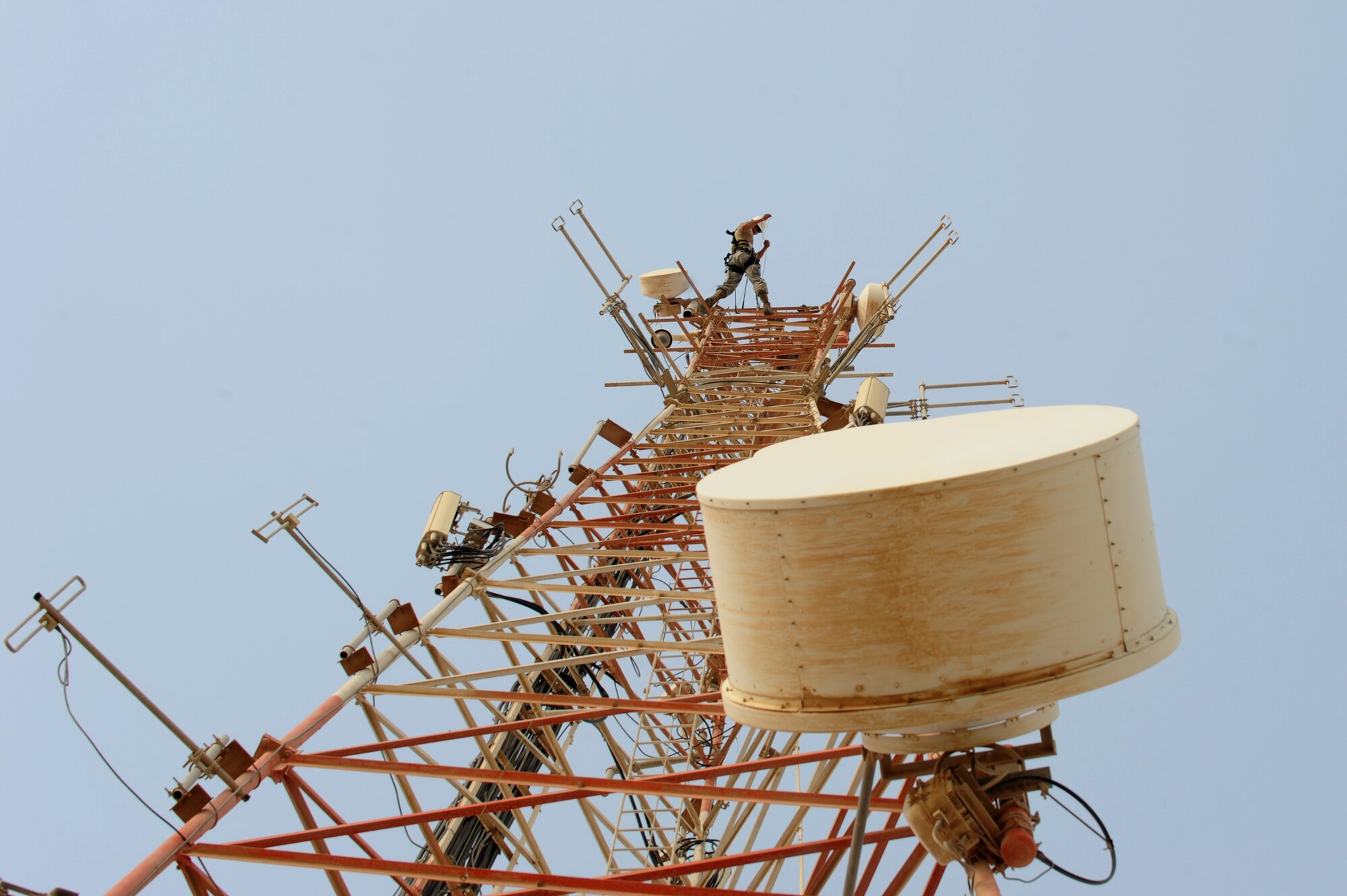 U.S. Air Force Senior Airman Cyrus Torres lowers a rope prior to moving two high frequency ground-to-air antennas in Southwest Asia, August 7, 2012. The move is in preparation for the construction material holding yard for the Technical Control Facility and Network Control Center expansion. Torres is assigned tot he 379th Expeditionary Communication Squadron and is deployed from Aviano Air Base, Italy. (U.S. Air Force photo/Staff Sgt. Sheila deVera)