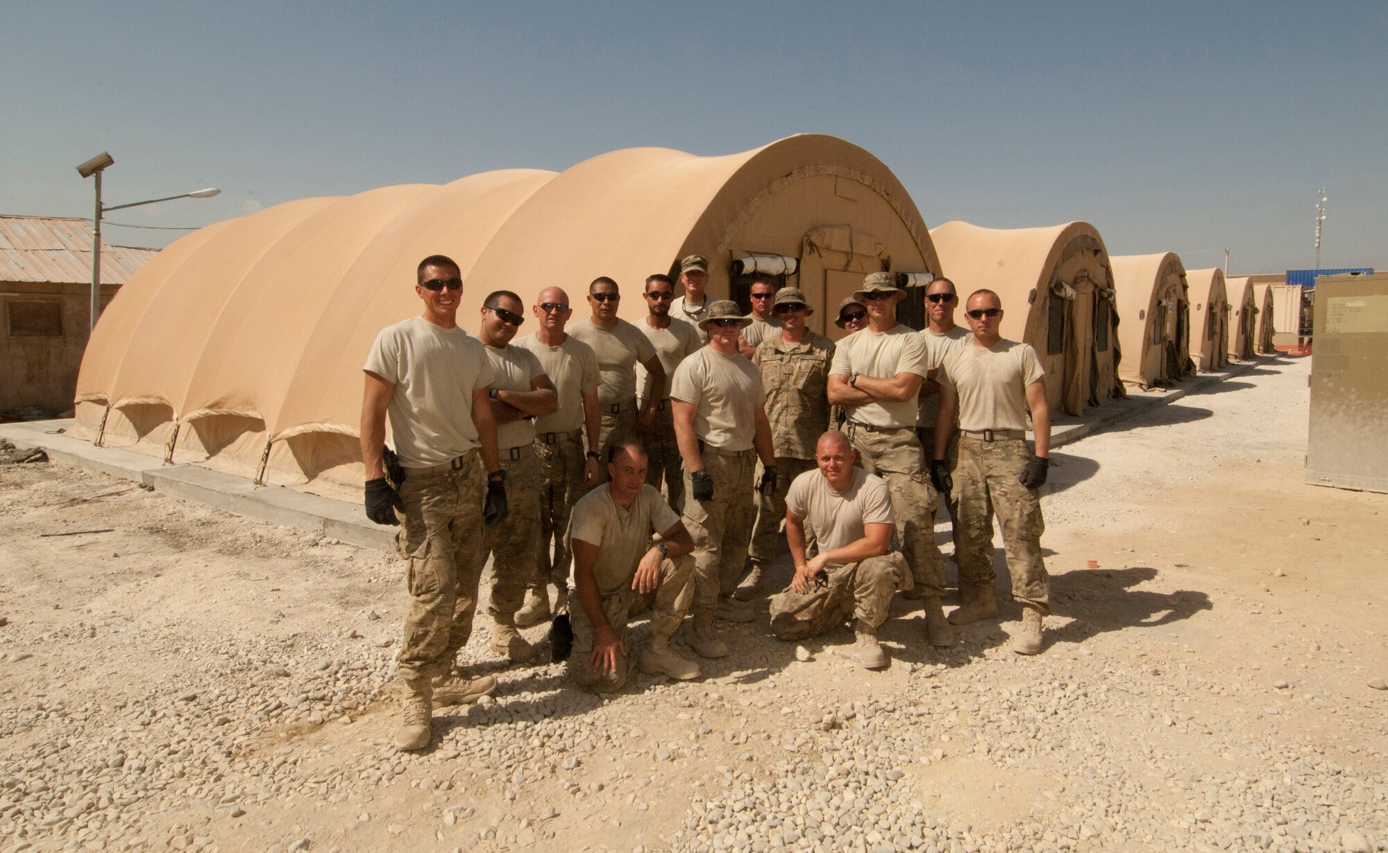 A crew of 14 Airmen assigned to the 455th Expeditionary Civil Engineer Squadron complete the construction of six tents at Bagram Airfield, Afghanistan, Aug. 23, 2012. The Airmen constructed the tents, called the Alaska tents, in two days, working in temperatures above 100 degrees. The tents were built to temporarily house transient Airmen. (U.S. Air Force photo/SSgt Jeff Nevison)