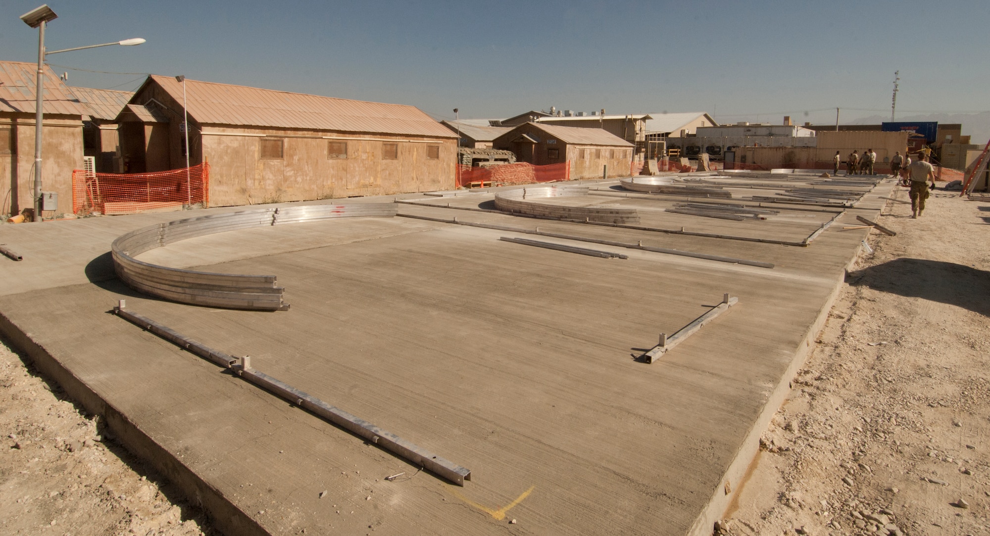 Cement foundation and framework bases for Alaska transient tents are put in place at Bagram Airfield, Afghanistan, Aug 22. 2012. A crew of 14 Airmen constructed the tents in two days, working in temperatures above 100 degrees. The tents were built to temporarily house transient Airmen. (U.S. Air Force photo/SSgt Jeff Nevison)