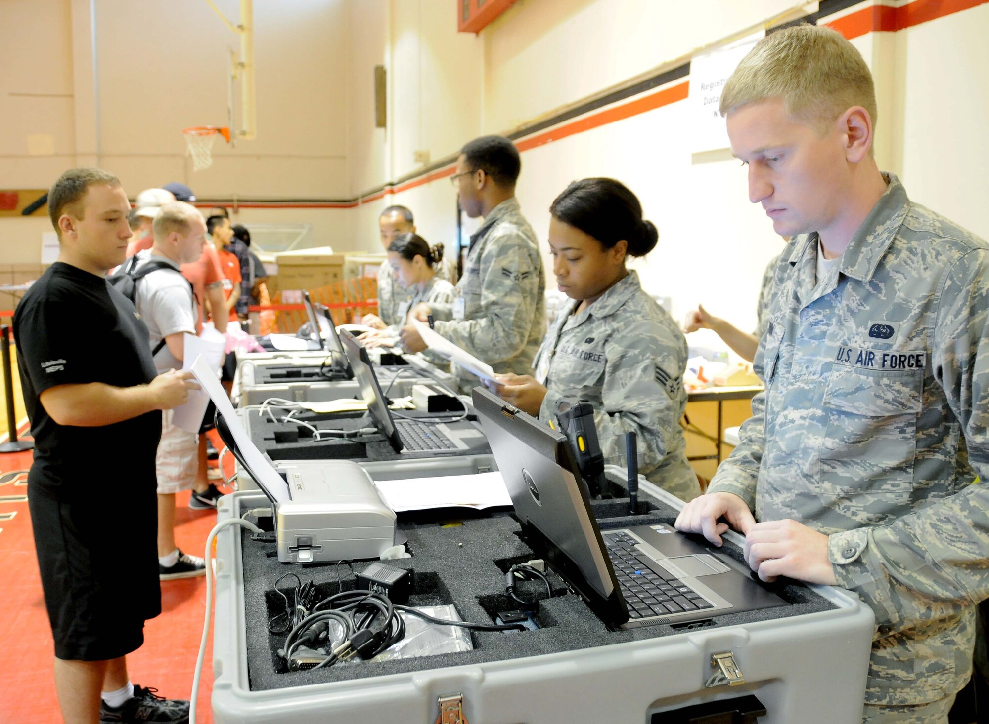 ANDERSEN AIR FORCE BASE, Guam- Members of Andersen Air Force Base simulate processing non combatant evacuee role players in route to the Continental United States as part of  exercise Beverly Palm 12-04, August 17. Andersen tested their ability to provide logistical support for the Movement  of the evacuees out of the Asian Pacific region.(U.S. Air Force photo by Senior Airman Jeffrey Schultze/Released)