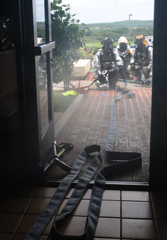 ANDERSEN AIR FORCE BASE, Guam -- The Andersen fire department responded to a simulated fire at the 254th Guam National Guard building during exercise Beverly Palm 12-04, August 22. This exercise is an annual operational readiness exercise that prepares Andersen for the upcoming combined unit compliancy inspection and ORI inspection in May 2013.(U.S. Air Force photo by Airman 1st Class Mariah Haddenham/Released)