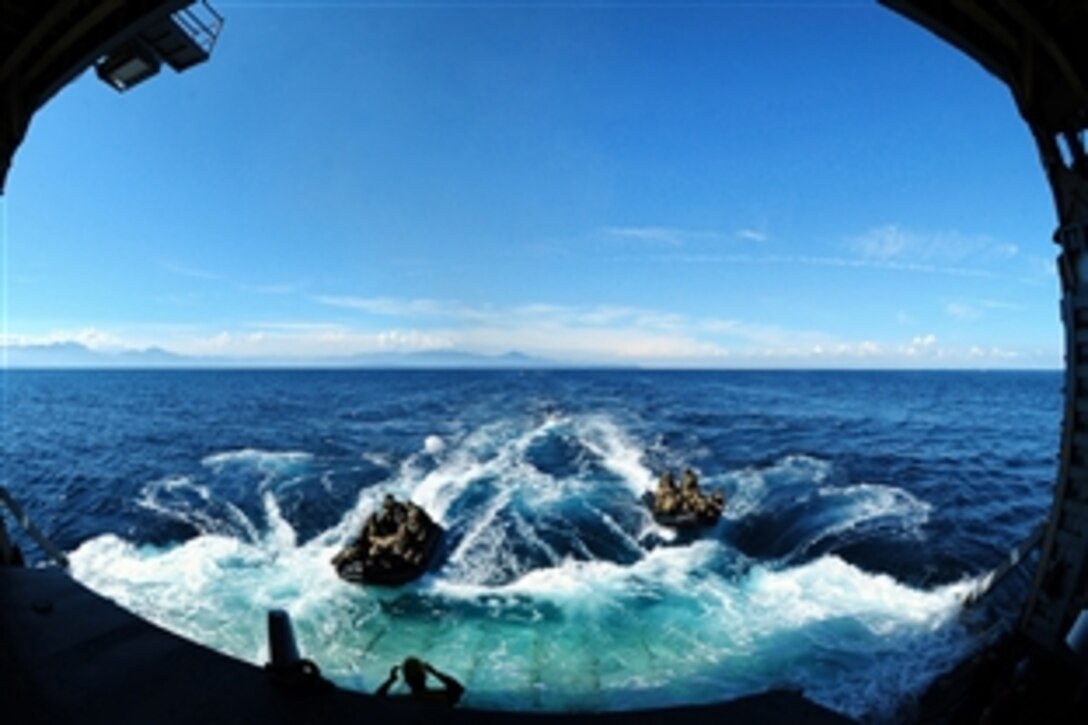 Marines approach the well deck of amphibious dock landing ship USS Tortuga after conducting open ocean operations using combat rubber crafts in Okinawa, Japan, Aug. 25, 2012. The Tortuga is apart of the only forward-deployed amphibious ready group. The Marines are assigned to the 31st Marine Expeditionary Unit.