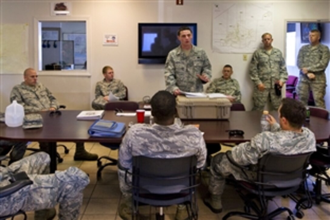 Air Force Tech. Sgt. Leonard Ooten, standing center, briefs airmen before departing Hurlburt Field, Fla., Aug. 26, 2012. Cerws evacuated Hurlburt Field assets as Tropical Storm Isaac approached the Gulf Coast region. Ooten is vehicle operation control center supervisor assigned to the 1st Special Operations Logistics Readiness Squadron.    