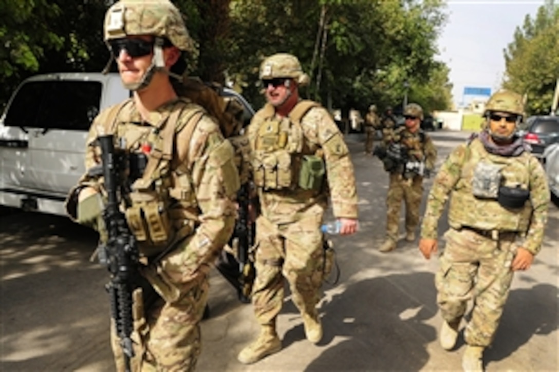 U.S. Army Cpl. Jacob Bath, left, provides security as leaders gather for a meeting in Farah City in Afghanistan's Farah province, Aug. 27, 2012. Bath is assigned to Provincial Reconstruction Team Farah. U.S. Army Lt. Col. Anthony Ulrich, center, attended the meeting.