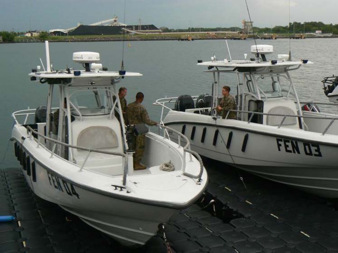 PUERTO QUETZAL, Guatemala—Marines with Detachment Martillo talk with one another while setting up communication equipment on Fuerza Espesciales Naval’s 32-foot Boston Whaler Justice boats.  The FEN is a section of the Guatemalan Navy special operations.  The Marines with the detachment have been working with the FEN and other units within the Guatemalan military over recent weeks to coordinate for their part in Operation Martillo.  Detachment Martillo, under operational control of U.S. Marine Corps Forces, South, is comprised of a number of units from II Marine Expeditionary Force.  Operation Martillo is an operation led by Joint-Interagency Task Force-South, of the U.S. Southern Command, and is designed to help stem the flow of narcotics through Central America and its Pacific and Caribbean coasts by denying transnational criminal organizations littorals used for illicit trafficking.  (Official U.S. Marine Corps photo//Released)