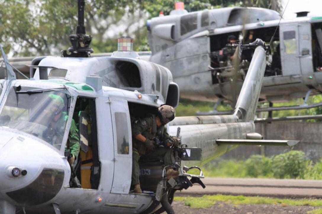 RETALHULEU, Guatemala—Staff Sgt. Travis A Jakovcic, a UH-1N Huey crewmember with Marine Light Attack Helicopter Squadron 467 looks back at another crew and aircraft during takeoff.  Four UH-1N Huey helicopter crews and aircraft from HMLA-467 are part of Detachment Martillo of U.S. Marine Corps Forces, South and are participating in Operation Martillo.  The detachment conducted a Mission Rehearsal Exercise prior to operations beginning in Guatemala.  Detachment Martillo, under operational control of U.S. Marine Corps Forces, South, is comprised of a number of units from II Marine Expeditionary Force.  Operation Martillo is an operation led by Joint-Interagency Task Force-South, of the U.S. Southern Command, and is designed to help stem the flow of narcotics through Central America and its Pacific and Caribbean coasts by denying transnational criminal organizations littorals used for illicit trafficking.  (Official U.S. Marine Corps photo//Released)