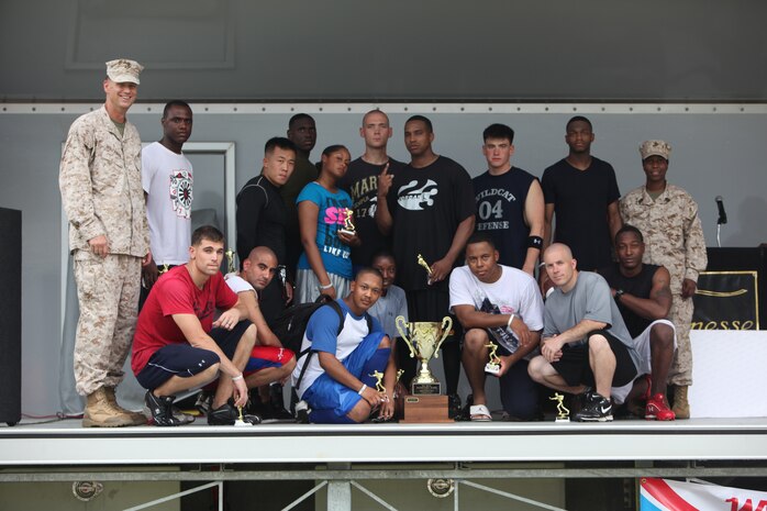 Marines and sailors with Combat Logistics Regiment 27, 2nd Marine Logistics Group pose for a picture after winning a flag football tournament during a barracks bash aboard Camp Lejeune, N.C., Aug. 22, 2012.  Servicemembers enjoyed the bouncy houses, rock climbing, sumo wrestling, tug-of-war and hypnotism. The participants also had the opportunity to purchase tickets for raffles to win gift cards, a TV, a DVD player and two bicycles throughout the event. 