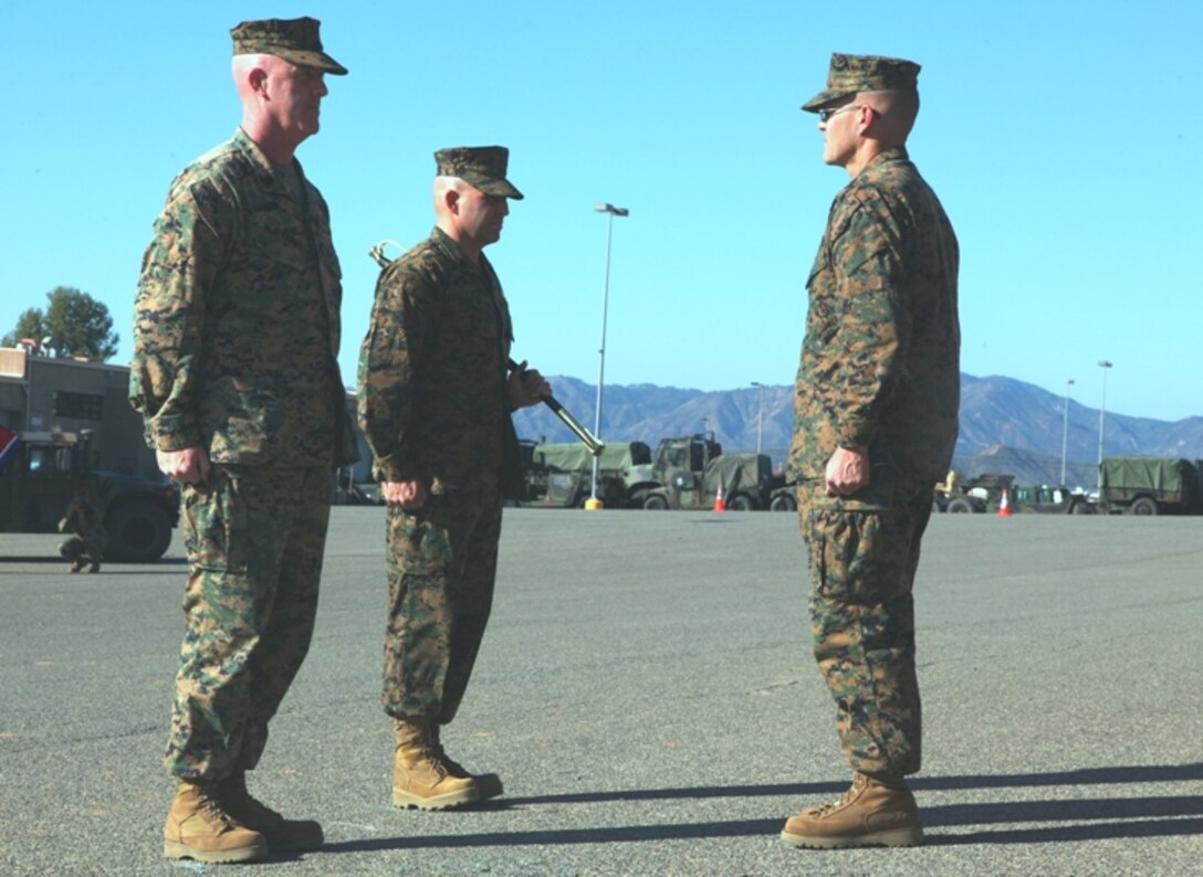 Sgt. Maj. Paul M. McElearney and Sgt. Maj. Richard Charron stand at the position of attention in front of Lt. Col. Daniel Dubbs, commanding officer, 7th Engineer Support Battalion, Combat Logistics Regiment 1, 1st Marine Logistics Group, during a Post and Relief ceremony at Camp Pendleton, Calif., Jan. 12.