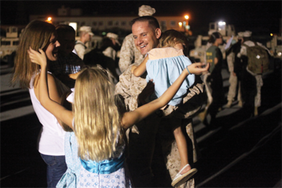 Master Sgt. Brannon A. Niesent is greeted at Camp Foster by his family upon his return from a 7-month deployment to Afghanistan Aug. 19. Niesent is the operations chief for Combat Logistics Battalion 4, Combat Logistics Regiment 3, 3rd Marine Logistics Group, III Marine Expeditionary Force.