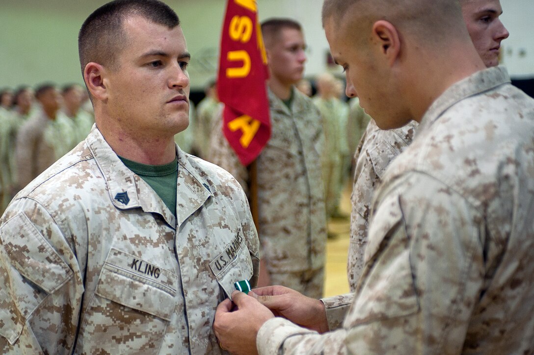 Sgt. Bobby Kling, platoon sergeant for Company A, second platoon, recieves his Navy and Marine Corps Commendation Medal during a ceremony at Marine Barracks Washington Aug. 27