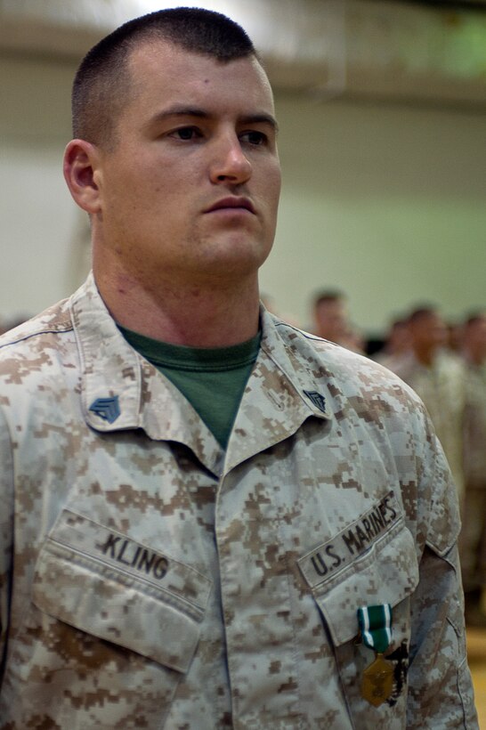 Sgt. Bobby Kling, platoon sergeant for Company A, second platoon, recieves his Navy and Marine Corps Commendation Medal during a ceremony at Marine Barracks Washington Aug. 27