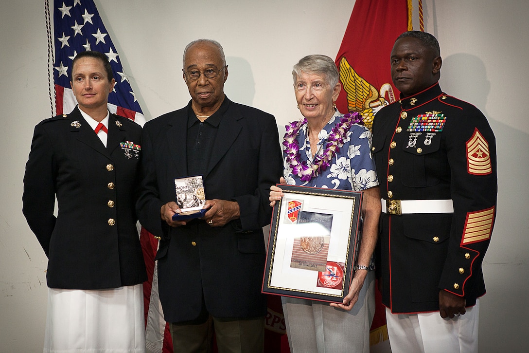 Former U.S. Marine Sgt. William S. Harris, Jr. (second from left), a World War II-era Montford Point Marine and Molokai, Hawaii, native, stands with his wife and Lt. Col. Carolyn Bird (left) and Sgt. Maj. Ansil Lewis (right), the commanding officer and sergeant major of Headquarters Battalion, after receiving the Congressional Gold Medal during a ceremony held in his honor on Marine Corps Base Hawaii, Aug. 27, 2012. Harris served in the Marine Corps from 1943 to 1952. He is among approximately 20,000 African-American men who joined the Marine Corps between 1942 to 1949 and received segregated recruit training at Montford Point, N.C. More than 13,000 of these Marines served overseas during World War II. U.S. House and Senate leaders awarded the medal — the highest civilian honor awarded as the utmost expression of national appreciation for distinguished achievements and contributions — to the Montford Point Marines in a ceremony at the U.S. Capitol Visitors Center, June 27. The Commandant of the Marine Corps held a parade in their honor at Marine Barracks Washington the following day, during which they were presented replica bronze medals. Veterans who were unable to attend were honored during individual ceremonies across the U.S.