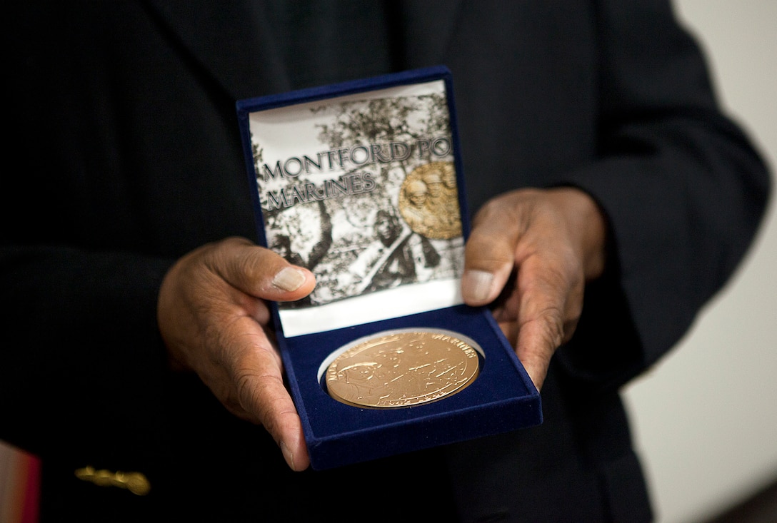 Former U.S. Marine Sgt. William S. Harris, Jr., a World War II-era Montford Point Marine and Molokai, Hawaii, native, displays his Congressional Gold Medal following a ceremony held in his honor on Marine Corps Base Hawaii, Aug. 27, 2012. Harris served in the Marine Corps from 1943 to 1952. He is among approximately 20,000 African-American men who joined the Marine Corps between 1942 to 1949 and received segregated recruit training at Montford Point, N.C. More than 13,000 of these Marines served overseas during World War II. U.S. House and Senate leaders awarded the medal — the highest civilian honor awarded as the utmost expression of national appreciation for distinguished achievements and contributions — to the Montford Point Marines in a ceremony at the U.S. Capitol Visitors Center, June 27. The Commandant of the Marine Corps held a parade in their honor at Marine Barracks Washington the following day, during which they were presented replica bronze medals. Veterans who were unable to attend were honored during individual ceremonies across the U.S.