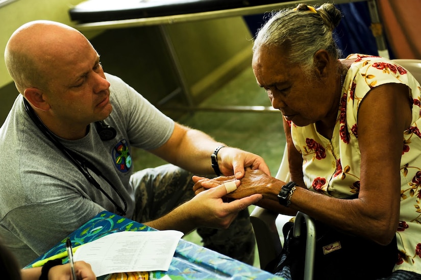 Air Force Capt. Jeff Herchler, Medical Element physician assistant, assesses a local patient’s condition at the health care provider station in Damitas, Costa Rica, during a two-day joint Medical Readiness Training Exercise. Together with Costa Rica’s Ministry of Health and Social Services, JTF-Bravo delivered medical care to 704 patients.   (U.S. Air Force photo/1st Lt. Christopher Diaz)