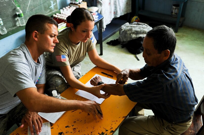 Senior Airman Maria Abello, Army Forces Battalion training NCO, listens to a Costa Rican patient explain his ailments in order to translate for Emergency Medical Technician Staff Sgt. Michael Canfield during a joint Medical Readiness Training Exercise. Together with Costa Rica’s Ministry of Health and Social Services, JTF-Bravo delivered medical care to 704 patients in the Costa Rican villages of San Juan and Damitas.  (U.S. Air Force photo/1st Lt. Christopher Diaz) 