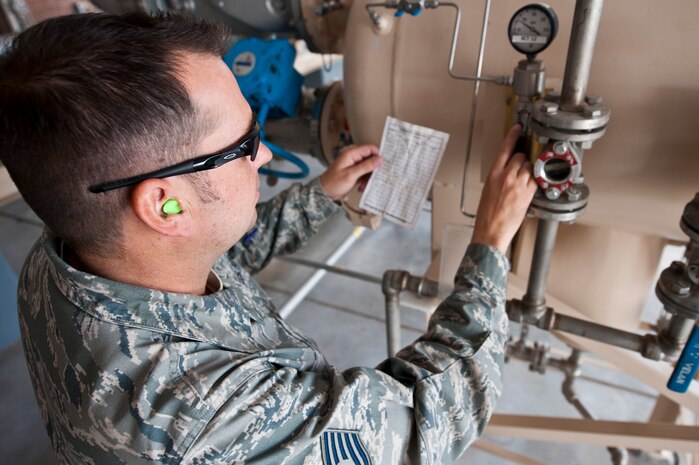 Tech. Sgt. Ray King, 99th Logistics Readiness Squadron fuels craftsman, checks a pressure gauge Aug. 23, 2012, at Nellis Air Force Base, Nev. The pressure gauge shows a direct reading for differential pressure between the inlet and outlet of a filter or separator. (U.S. Air Force photo by Airman 1st Class Jason Couillard)