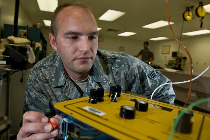 Senior Airman Kevin Amrich, 57th Maintenance Group Precision Measurement Equipment Laboratory journeyman, works on a thermocouple calibrator during the Logistics Compliance Assessment Program inspection Aug. 24, 2012, at Nellis Air Force Base, Nev. Units participating in an LCAP are given 45 days of notice prior to the inspection. (U.S. Air Force photo by Airman 1st Class Daniel Hughes)