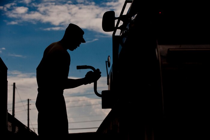 Senior Airman Bradley Cassidy, 99th Logistics Readiness Squadron vehicle operations journeyman, secures a bobtail truck to a loading vehicle during the Logistics Compliance Assessment Program inspection Aug. 23, 2012, at Nellis Air Force Base, Nev. Compliance with safety is a major goal of the 99th LRS. (U.S. Air Force photo by Staff Sgt. Christopher Hubenthal)