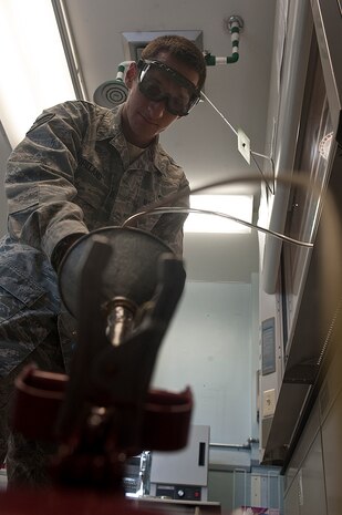 Senior Airman Taj Copeland, 99th Logistics Readiness Squadron fuels lab technician, checks for sediments in fuel samples to ensure cleanliness during the Logistics Compliance Assessment Program inspection Aug. 23, 2012, at Nellis Air Force Base, Nev. The purpose of an LCAP inspection is to provide leadership at all levels an evaluation of a unit's ability to perform key logistics processes in a safe, standardized, repeatable, and technically compliant manner. (U.S. Air Force photo by Staff Sgt. Christopher Hubenthal)