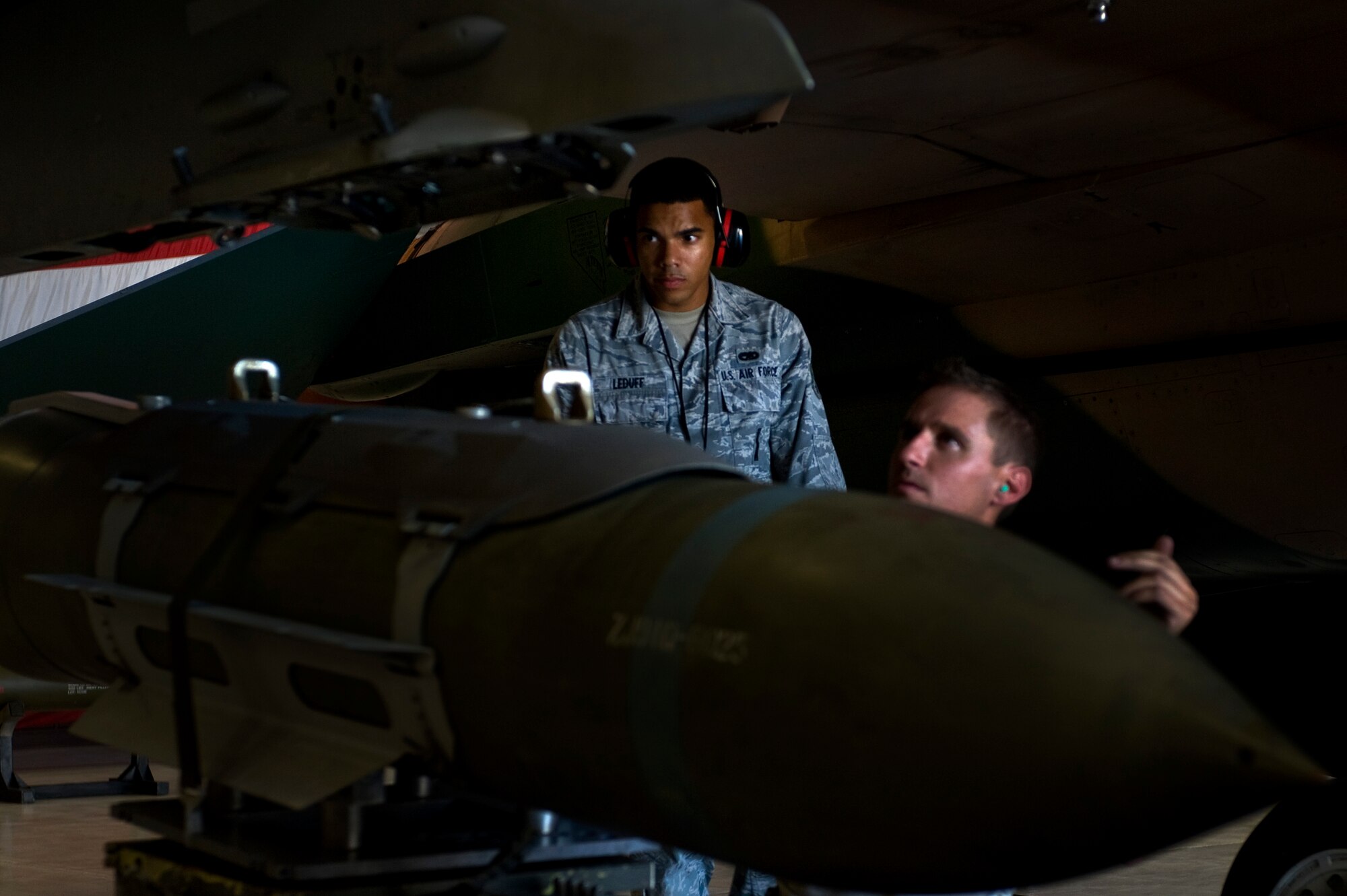 Senior Airman Marcel Leduff, 57th Maintenance Group F-16 weapons lead crew member, evaluates  Staff Sgt. Michael Briston, 57th Maintenance Group weapons crew chief, to the standard of a Logistics Compliance Assessment Program Aug. 27, 2012, at Nellis Air Force Base, Nev. The 57th MXG scored above the Combat Air Force average for scores. (U.S. Air Force photo by Airman 1st Class Christopher Tam)
