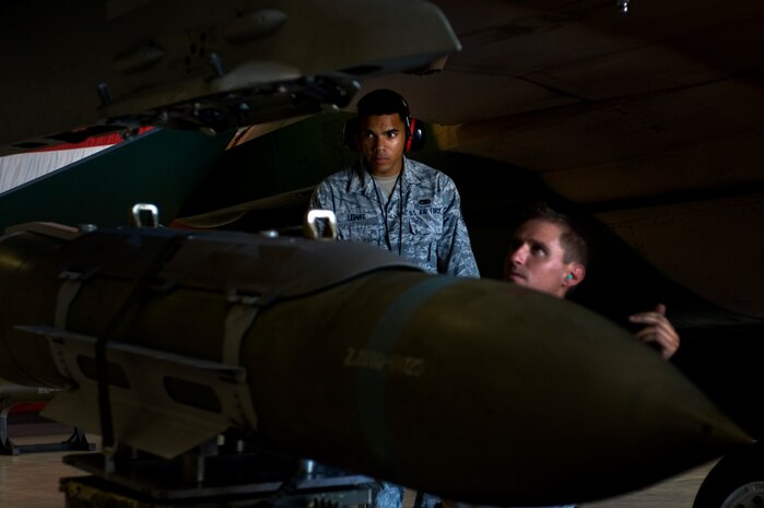 Senior Airman Marcel Leduff, 57th Maintenance Group F-16 weapons lead crew member, evaluates  Staff Sgt. Michael Briston, 57th Maintenance Group weapons crew chief, to the standard of a Logistics Compliance Assessment Program Aug. 27, 2012, at Nellis Air Force Base, Nev. The 57th MXG scored above the Combat Air Force average for scores. (U.S. Air Force photo by Airman 1st Class Christopher Tam)