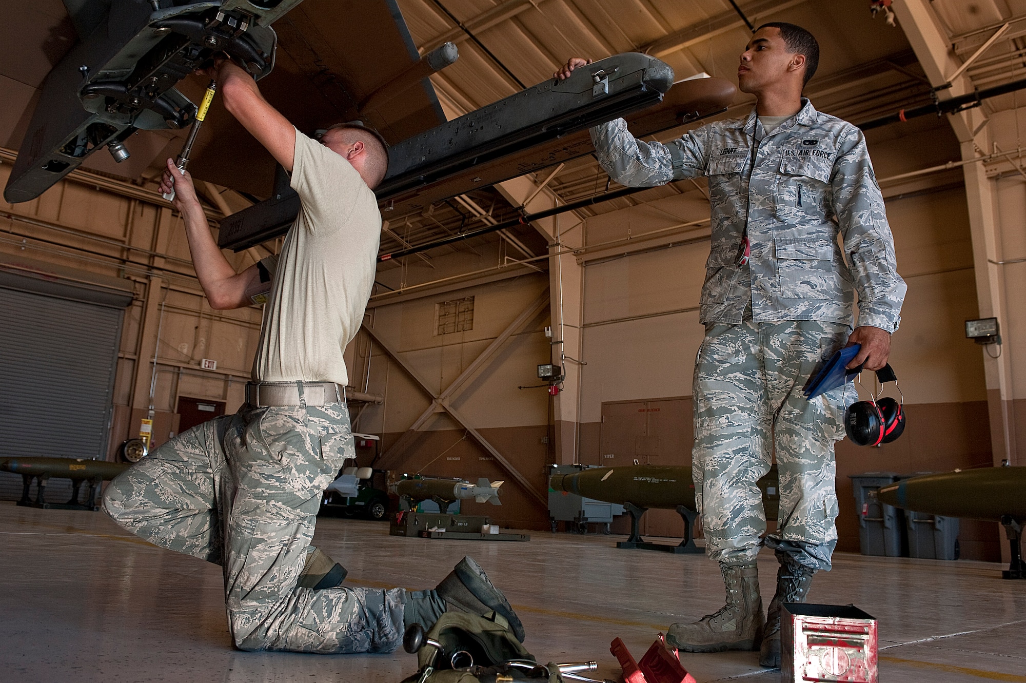 Senior Airman Marcel Leduff, 57th Maintenance Group F-16 weapons lead crew member, evaluates Staff Sgt. Michael Briston, 57th Maintenance Group weapons crew chief, to the standard of a Logistics Compliance Assessment Program Aug. 27, 2012, at Nellis Air Force Base, Nev. The 57th MXG scored above the Combat Air Force average for scores. (U.S. Air Force photo by Staff Sgt. Christopher Hubenthal)
