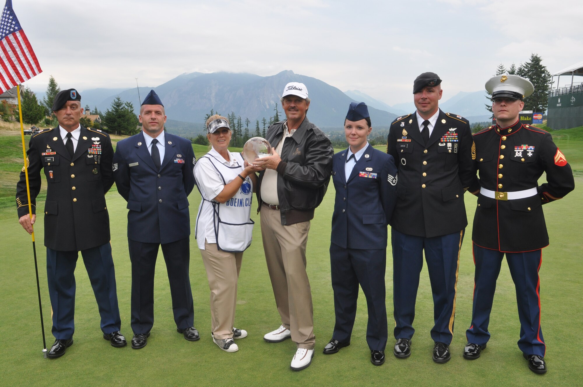 U.S. service members stand with Jay Don Blake, the 2012 Boeing Classic golf tournament winner, and his wife Marci, at Tournament Player's Club Snoqualmie Ridge golf course in Snoqualmie, Wash. The service members were selected to perform duties as honorary tee callers and 18th hole flag pullers during Military Appreciation Day at the Boeing Classic tournament. (U.S. Air Force photo/Staff Sgt. Sean Tobin)