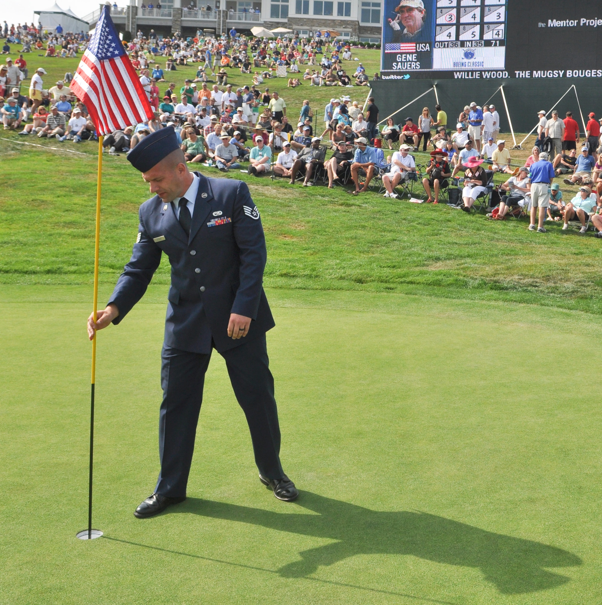 Staff Sgt. Eric Dasher, a precision measurement equipment laboratory technician from the 62nd Maintenance Squadron, Joint Base Lewis-McChord, Wash., replaces the flag Aug. 26, 2012, at the 18th green of Tournament Player's Club Snoqualmie Ridge golf course in Snoqualmie, Wash. Dasher was one of ten U.S. service members selected to perform duties as honorary tee callers and 18th hole flag pullers during Military Appreciation Day at the Boeing Classic tournament held at the course. (U.S. Air Force photo/Staff Sgt. Sean Tobin)
