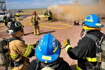 Schriever firefighters and El Paso County Sherriff’s Office emergency services division personnel conduct live training Aug. 24 here. The training is one of job performance requirements for reoccurring proficiency for both organizations. During the event, Schriever and El Paso personnel trained on hose evolutions, personal protective equipment, donning and doffing the self-contained breathing apparatus as well as accountability and communication. (U.S. Air Force photo/Dennis Rogers)