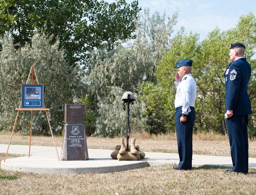 Col. Thomas Goulter, 28th Mission Support Group commander, (left) and Chief Master Sgt. James Herkel, 28th Security Forces Squadron manager, salute the memorial of fallen Airman 1st Class Leasha Jill Bjork-Hardesty, 28th Security Forces Squadron defender, during an unveiling ceremony at Memorial Park on Ellsworth Air Force Base, S.D., Aug. 27, 2012. Bjork-Hardesty lost her life in a vehicle mishap while deployed in support of Operation Southern Watch in 1999. (U.S. Air Force photo by Airman 1st Class Alystria Maurer/Released)