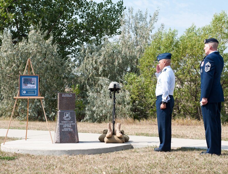 Col. Thomas Goulter, 28th Mission Support Group commander, (left) and Chief Master Sgt. James Herkel, 28th Security Forces Squadron manager, salute the memorial of fallen Airman 1st Class Leasha Jill Bjork-Hardesty, 28th Security Forces Squadron defender, during an unveiling ceremony at Memorial Park on Ellsworth Air Force Base, S.D., Aug. 27, 2012. Bjork-Hardesty lost her life in a vehicle mishap while deployed in support of Operation Southern Watch in 1999. (U.S. Air Force photo by Airman 1st Class Alystria Maurer/Released)