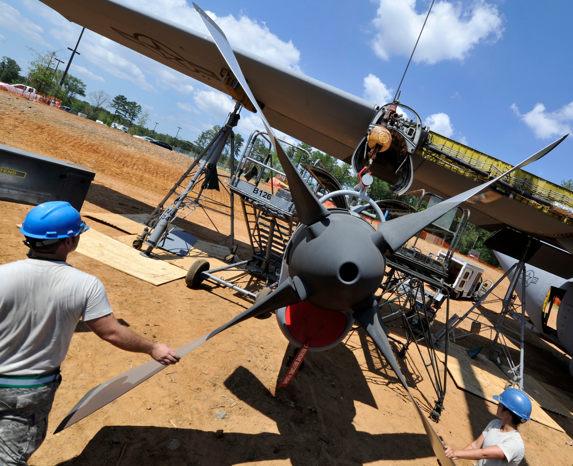 The 19th Aircraft Maintenance Squadron and the 19th Component Maintenance Squadron guide a turboprop to be attached to a C-130E Aug, 28, 2012, at Jacksonville, Ark. The C-130 is being reassembled for a static display in front of the Little Rock Air Force Base - City of Jacksonville Joint Education Center. (U.S. Air Force photo by Staff Sgt. Caleb Pierce)