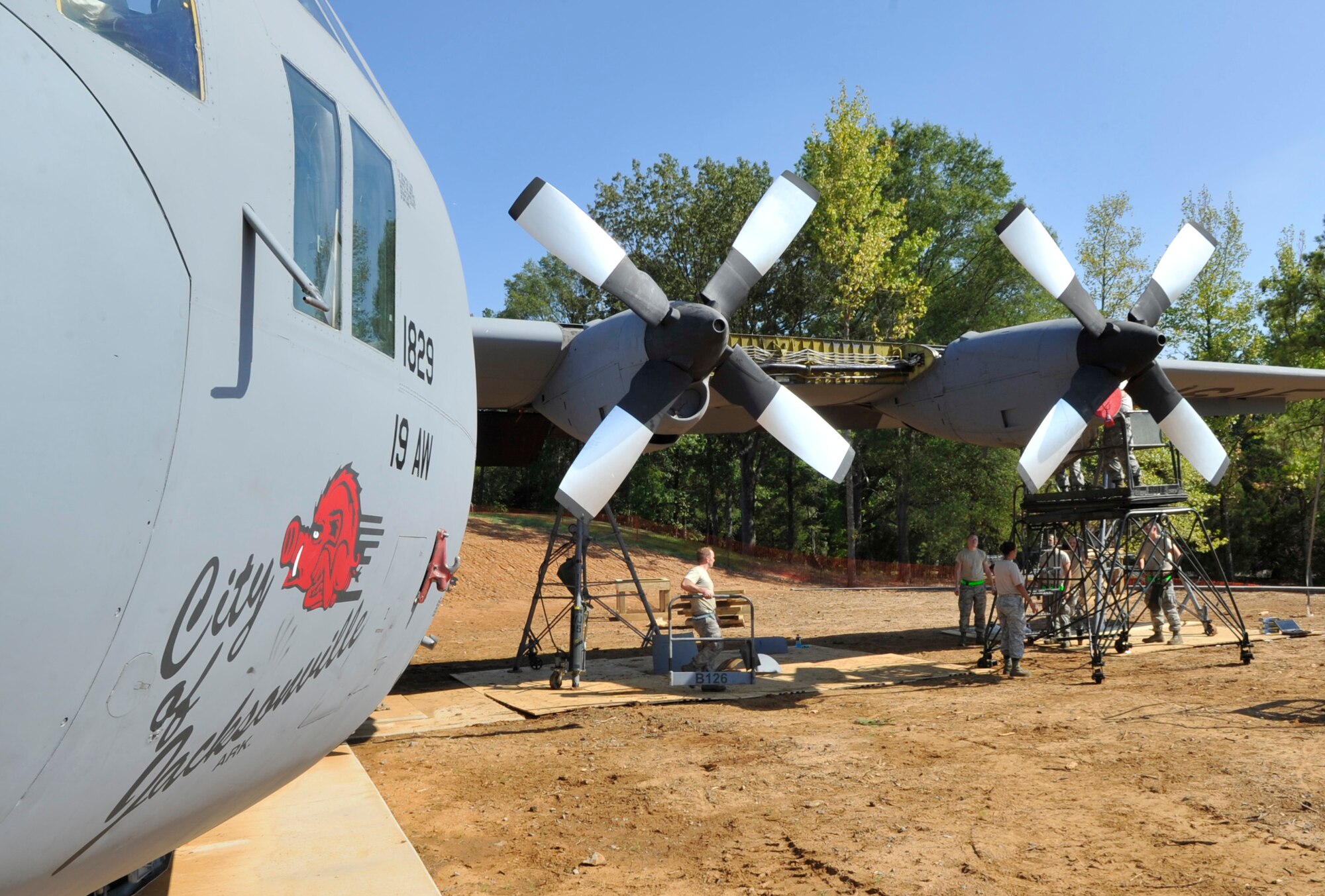 The 19th Component Maintenance Squadron, Aircraft Maintenance Squadron and Equipment Maintenance Squadron work together to reassemble a C-130E Aug. 28, 2012, in Jacksonville, Ark. This C-130 has been in service in Air Force for almost 50 years and is now being retired in front of the Little Rock Air Force Base - City of Jacksonville Joint Education Center. (U.S. Air Force photo by Staff Sgt. Caleb Pierce) 
